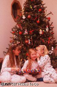 Three girls opening Christmas presents